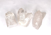 Load image into Gallery viewer, Three clear crystal rocks on a white background