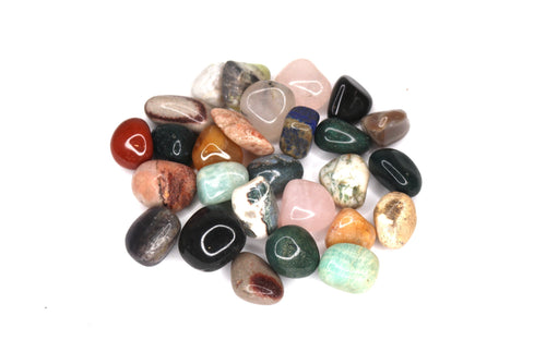 Assorted multicolored stones on a white background