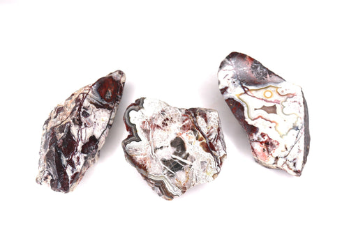 Three marbled stone cabochons on a white background