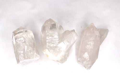 Three clear crystal rocks on a white background